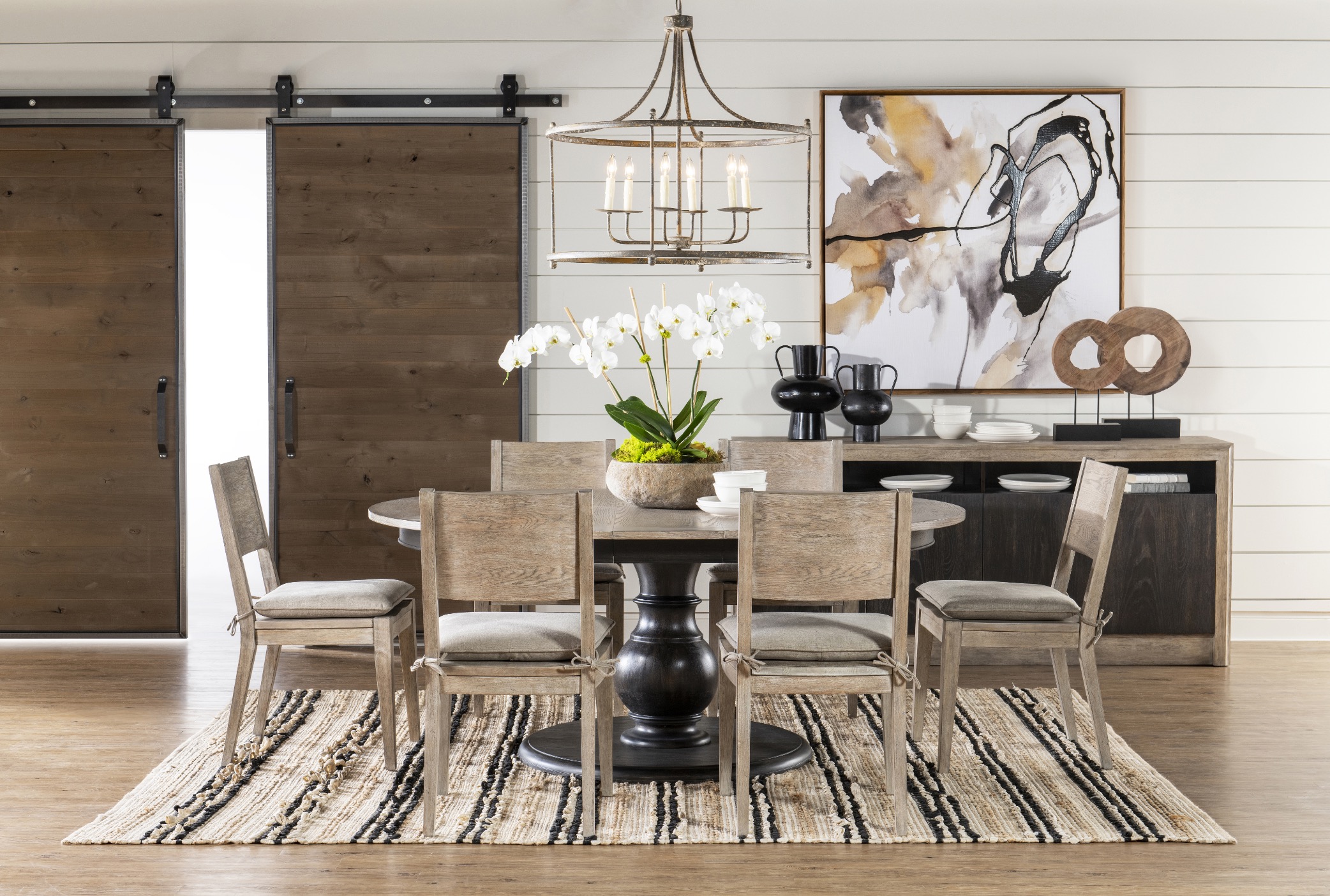 Dining room with modern artwork and barn doors