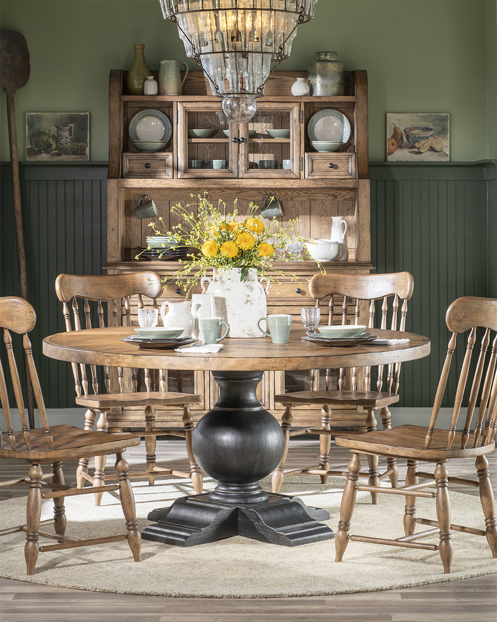 Black base and wood top pedastal table with black chairs