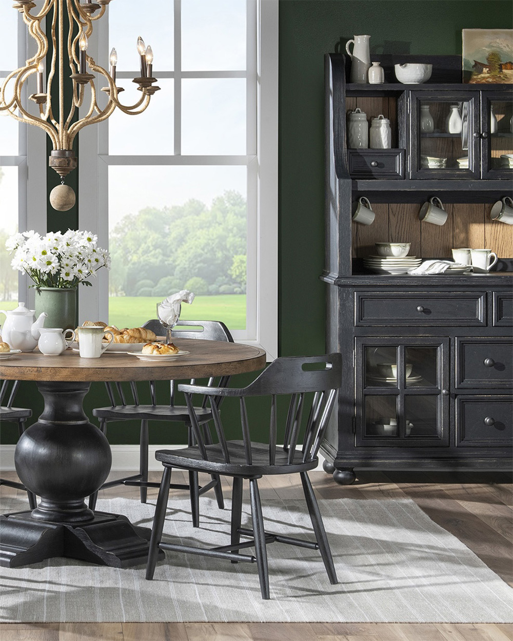 Black base and wood top pedastal table with black chairs
