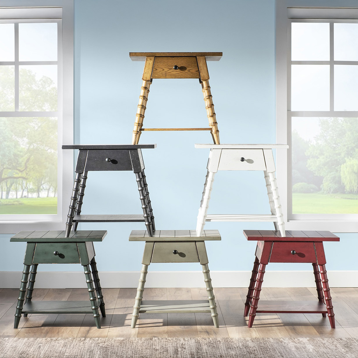 Country style end tables or nightstands in muted colors stacked in a triangle